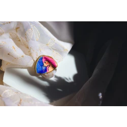 A handcrafted contemporary art portrait ring made from polymer clay, hand-painted, with a unique and lightweight design that combines elegance and comfort as a wearable piece of art
