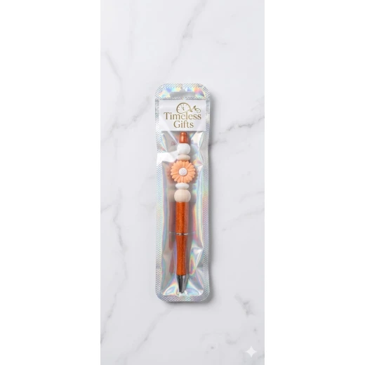 Pen decorated with orange beads and an elegant flower, featuring a beautiful handmade design Perfect for gifts and daily use, adding a feminine and stylish touch to your desk or study Pen decorated with orange beads and an elegant flower, featuring a beautiful handmade design Perfect for gifts and daily use, adding a feminine and stylish touch to your desk or study